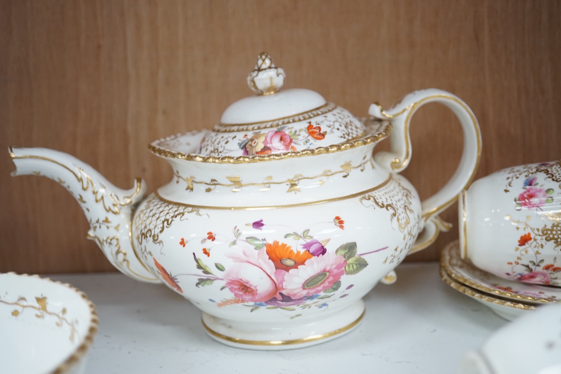 A Coalport floral part teaset, c.1825, to include teapot, sandwich plates and cups & saucers. Condition - poor to fair